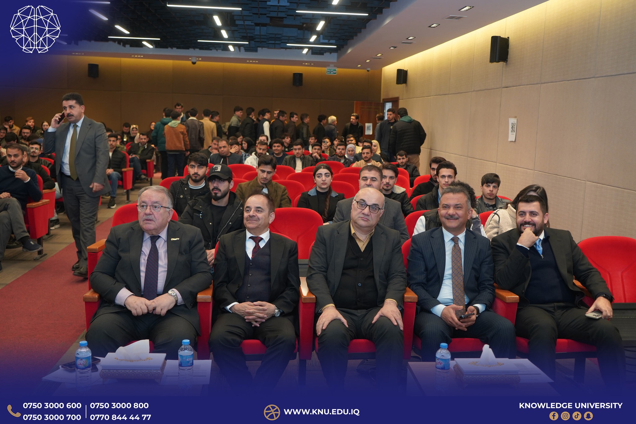 Engaged audience members participating in the crucial conversation about educational transformation